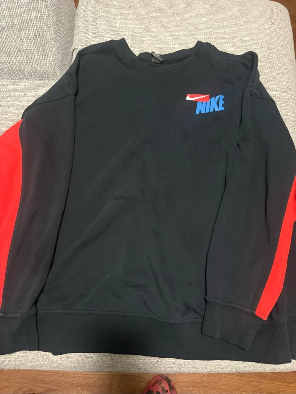 Nike Black Crewneck Sweatshirt with Red Sleeve Panels and Blue Logo